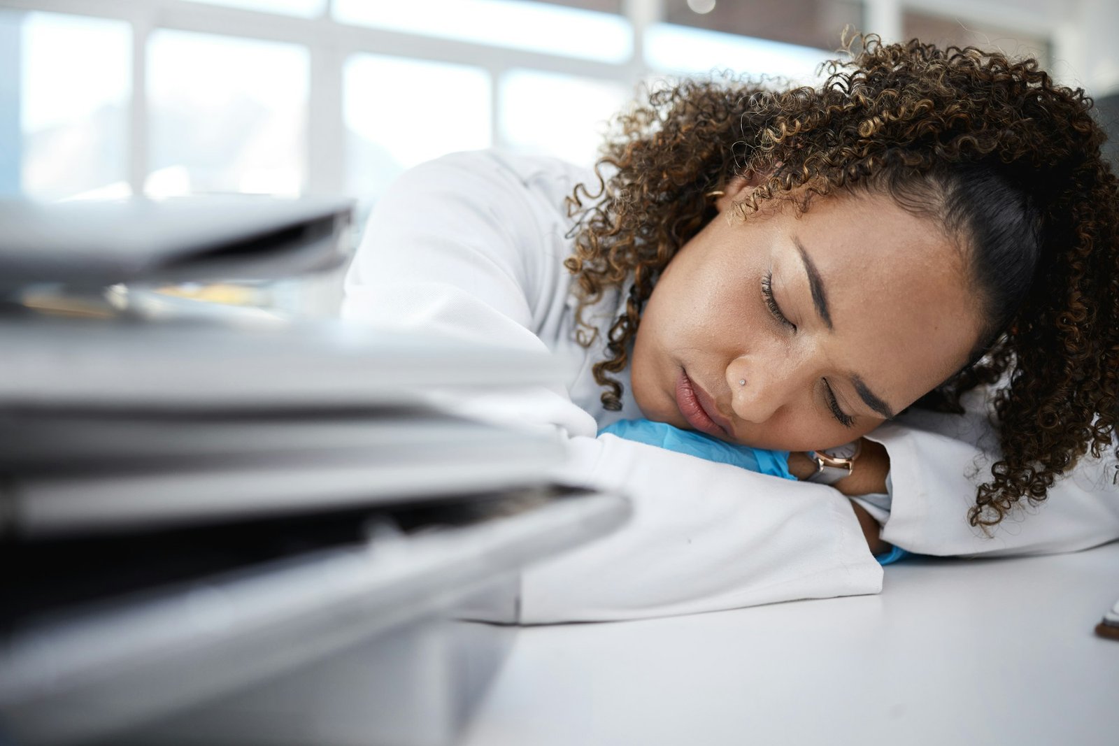 Science, tired and scientist sleeping in lab after working on innovation experiment, test or resear